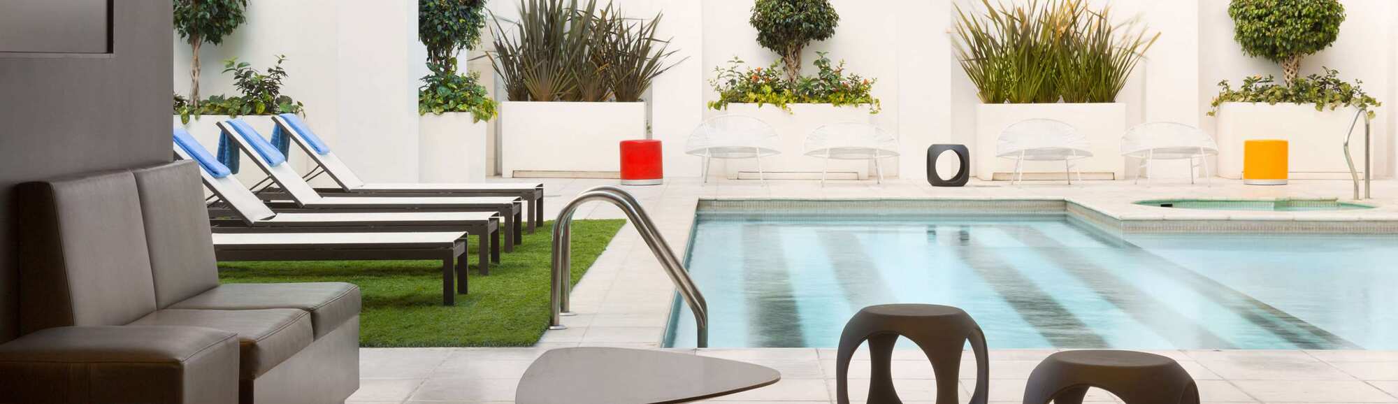 Seating area and lounge chairs next to a pool