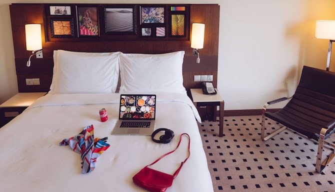Radisson Blu Hotel Nairobi, Upper Hill - Superior Room MacBook, Headphones, Dress, Handbag and Cola on Bed