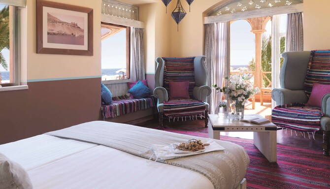Radisson Blu Resort, El Quseir - Sea View Suite Bedroom Bed and Chairs