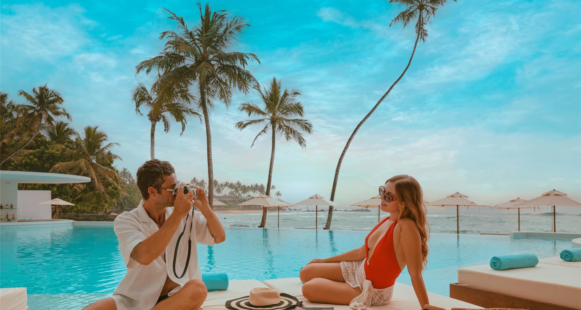 A couple relaxing at Taboo Beach pool