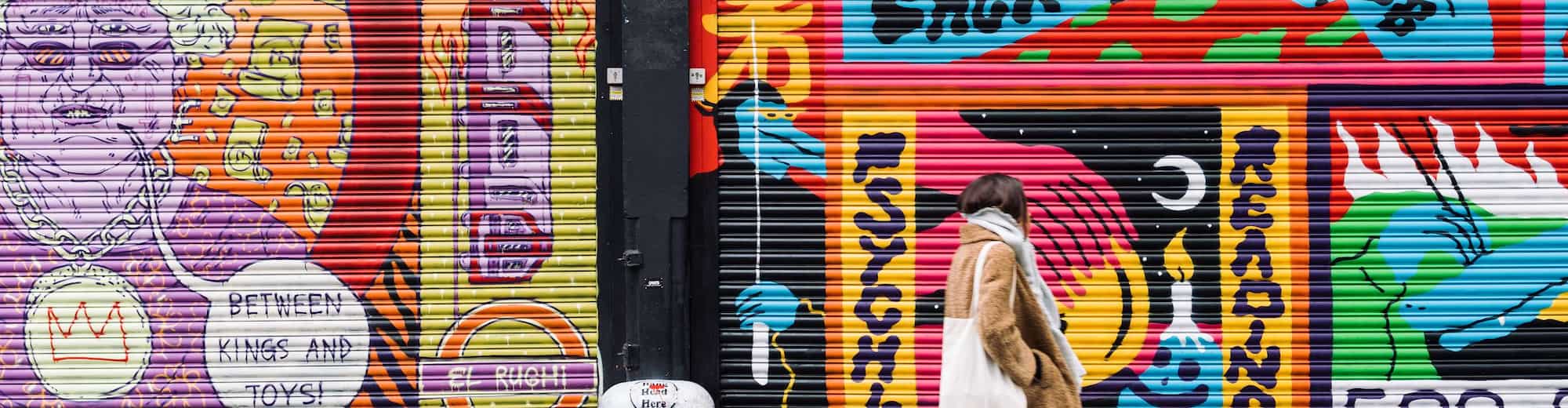 Artotel Brand - Woman walking on street with graffity walls