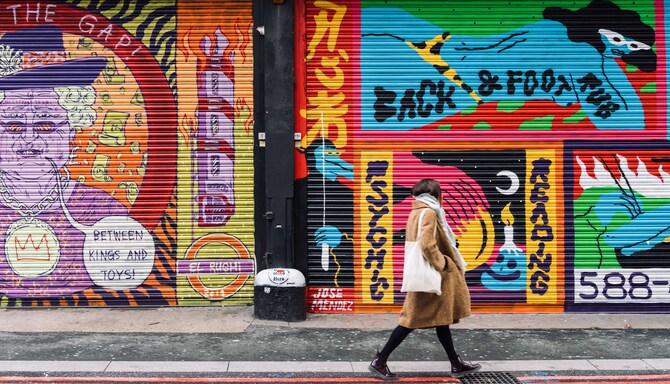 Artotel Brand - Woman walking on street with graffity walls