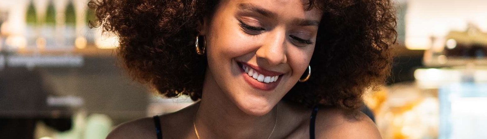 Blog images - Person drinking coffee and reading a book - 5 dining spots in Riga