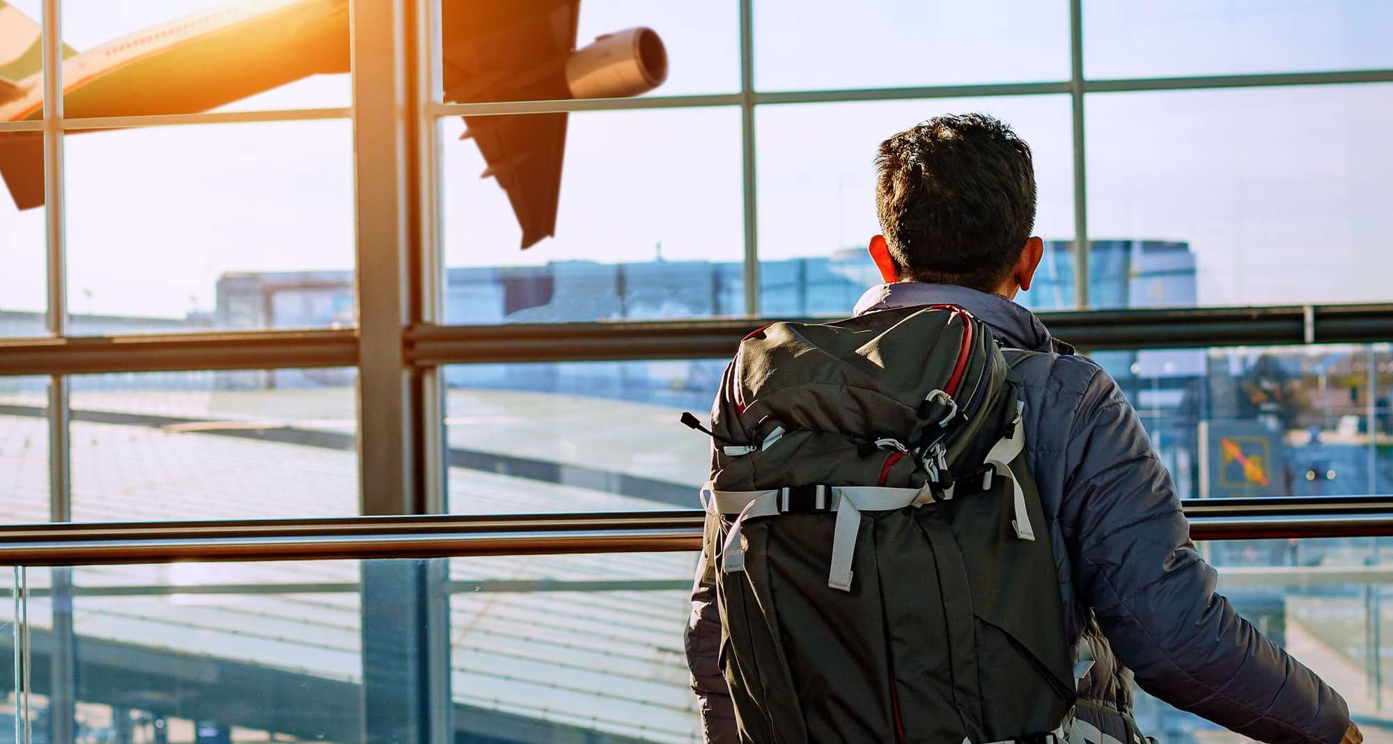 Blog images - 2023 - The four best places for vacation in October Man watching plane hero