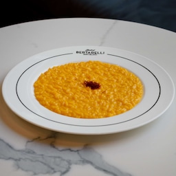 Blog images - 2023 - Culinary Tales Flavors of Milan with Luca Milanese Saffron Risotto Recipe risotto on a white table