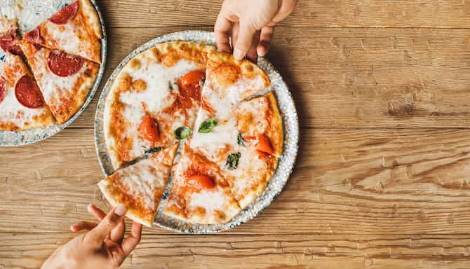 Blog images - A Culinary Journey: Unveiling the Best Italian Dishes - people sharing pizza