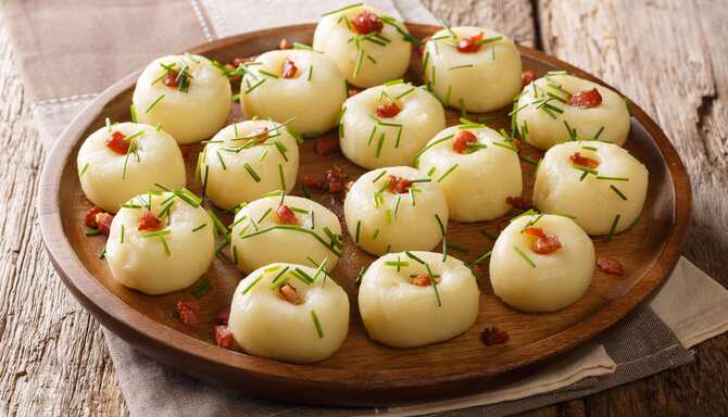 Blog images - The best Polish Traditional Food to fall in love with - Kluski śląskie on a wooden plate