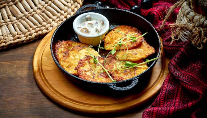 Blog images - The best Polish Traditional food to fall in love with - Placki ziemniaczane on a table