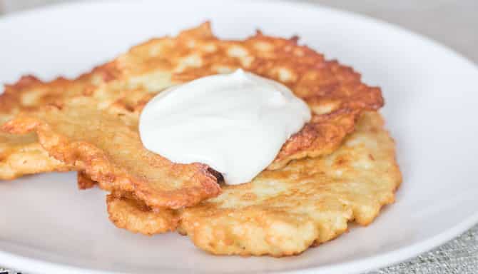 Blog images - The best Polish Traditional food to fall in love with - Placki ziemniaczane on a plate
