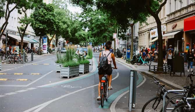 Blog images - 2025 - Things to Do in Berlin Exploring the Vibrant German Capital Destination Woman riding a bicycle on t