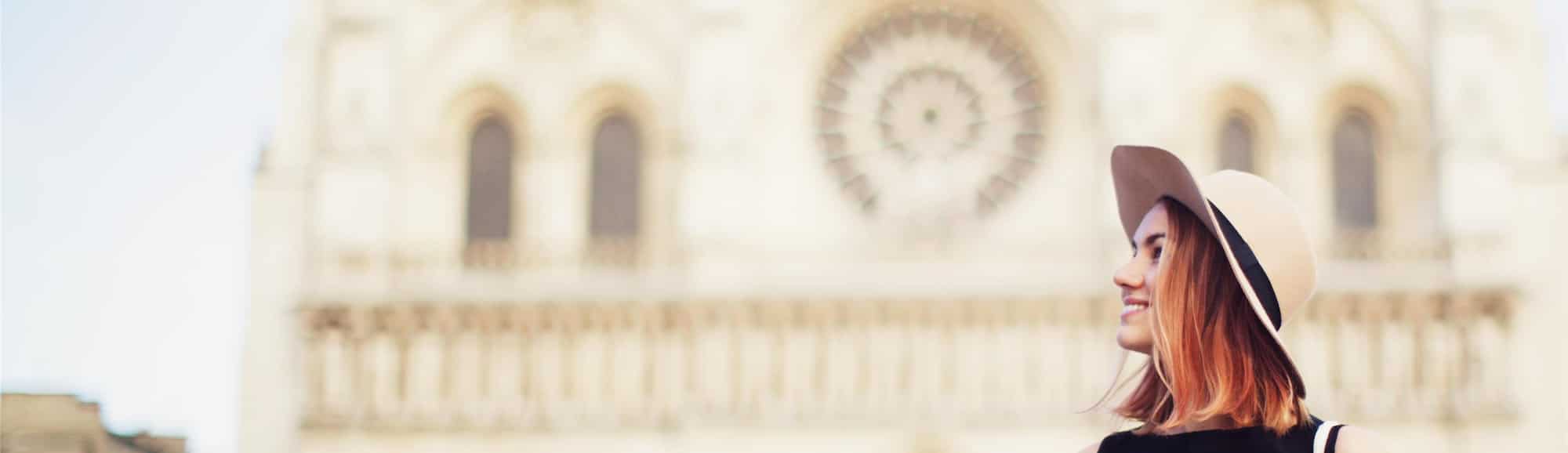 Blog images - 2025 - Top Things to Do in Paris History Shopping and Culture Young woman in front of Cathedral in Paris Fr