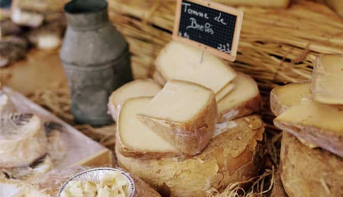 Blog images - 2025 - Things to Do in Lyon a Journey of Discovery destination cheeses displayed in a Lyon market
