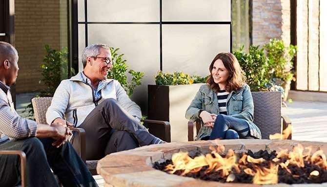 Group of people enjoying fire pit in outdoor space