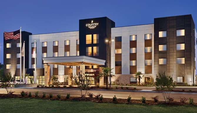 Exterior view of hotel s entrance at dusk