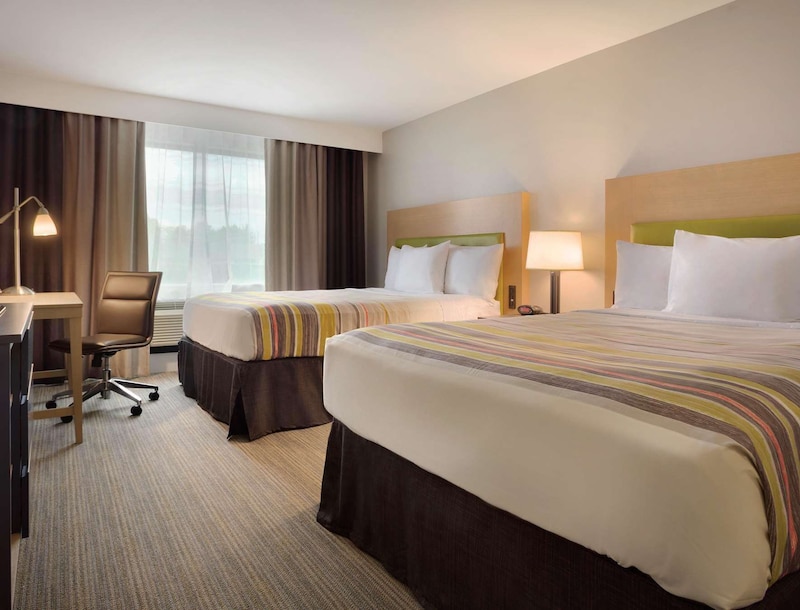 Room with two queen beds and desk