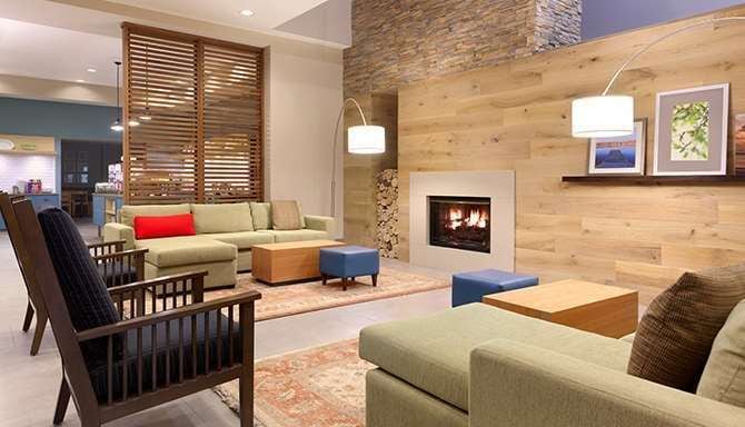 Newly remodeled hotel lobby with sofas and fireplace