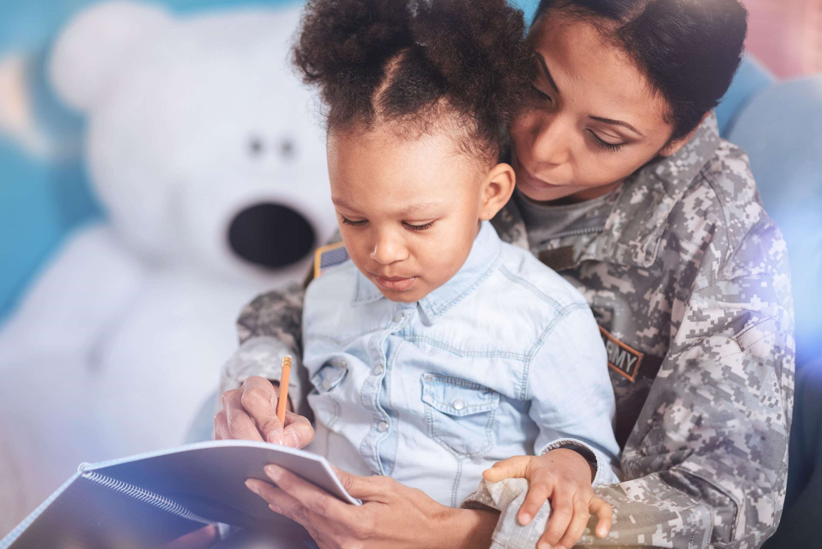 Mother in Army uniform holding daughter