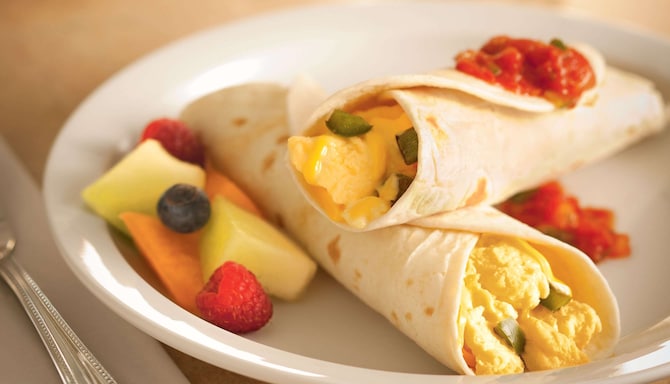 Burrito relleno con huevos revueltos esponjosos con salsa mexicana