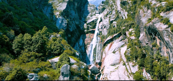 Explore hidden waterfalls in the natural terrain of the serene Dharamshala peaks