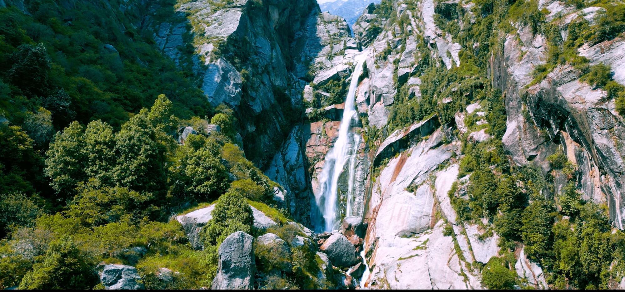Explore hidden waterfalls in the natural terrain of the serene Dharamshala peaks
