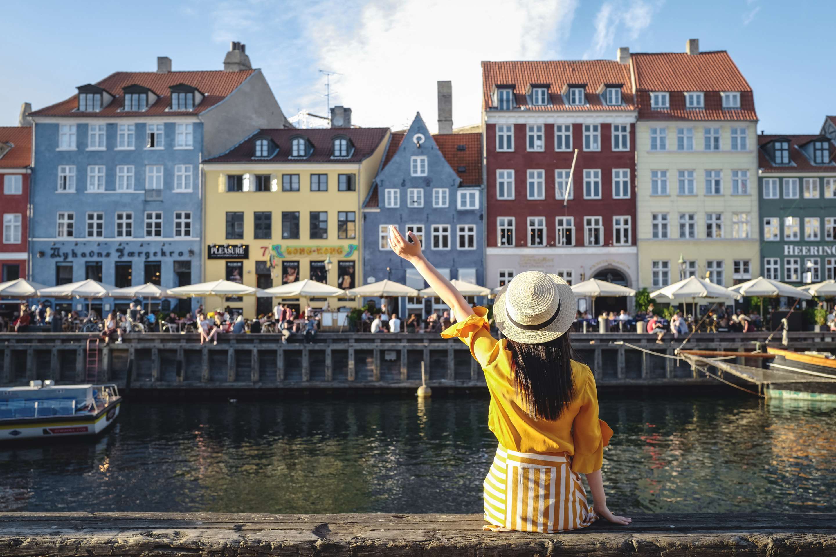 Marketing Campaigns NOBA - Copenhagen Nyhavn young woman sitting in front of colorful houses