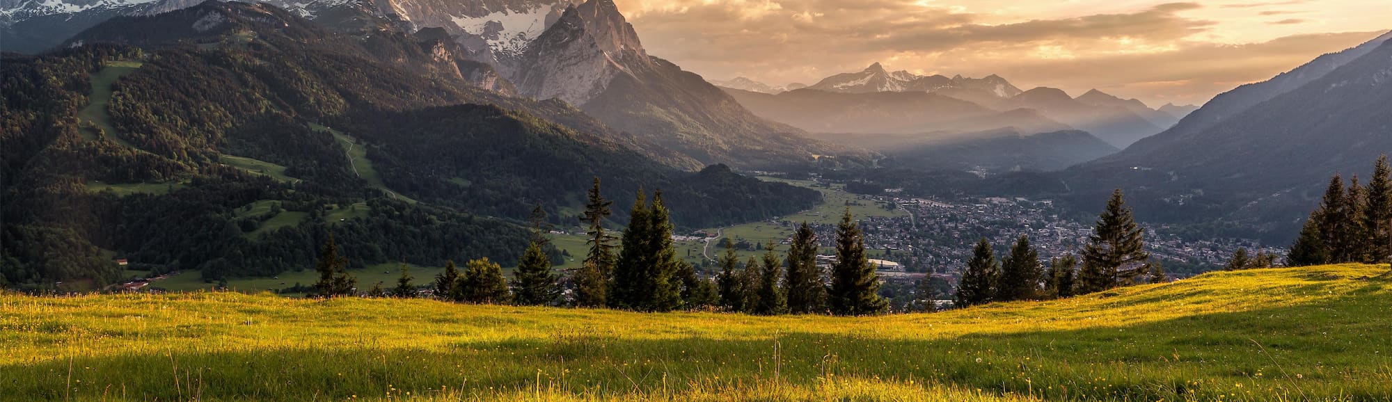 Radisson Hotel Group Responsible Business Report 2025 (hero image: landscape of mountain and lush, green fields)