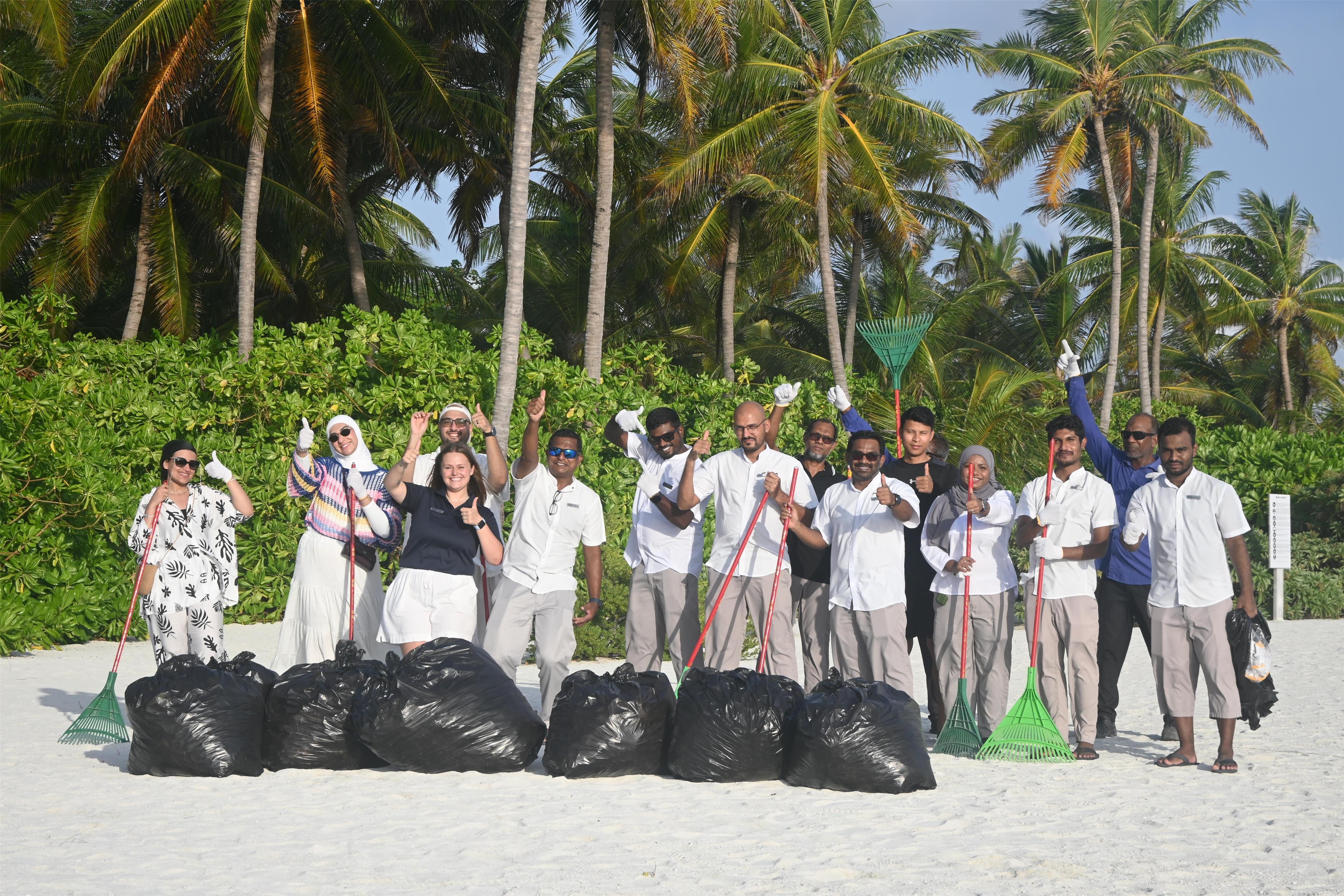 The team at Radisson Blu Resort, Maldives, participate in a beach clean-up.