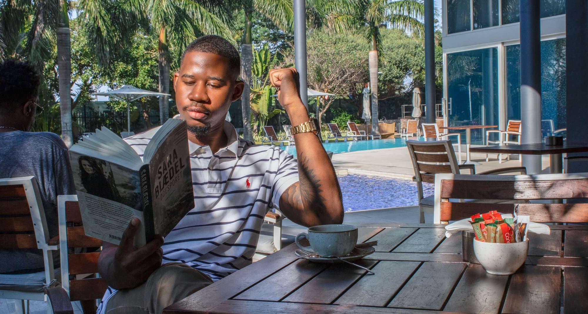 Man reading book outside