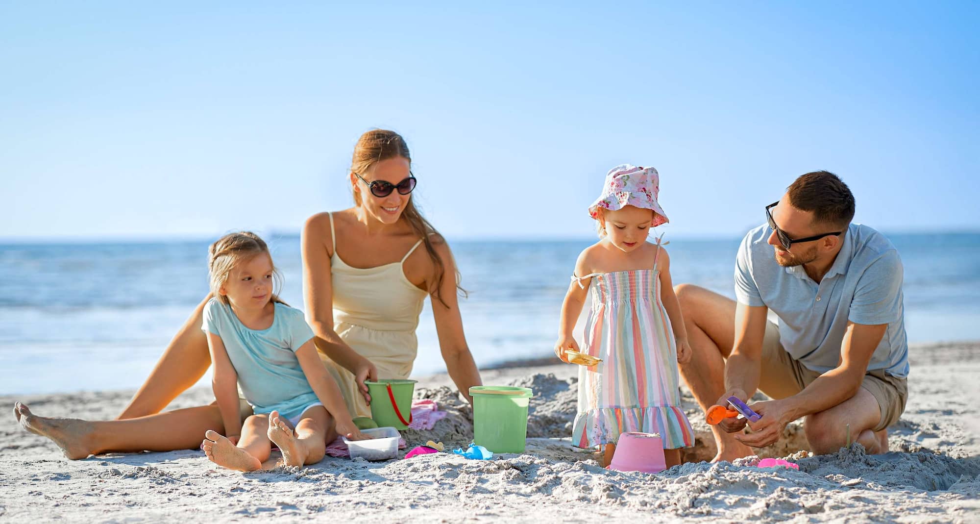 Radisson Blu Resort, Maldives - Family playing with sand on the beach