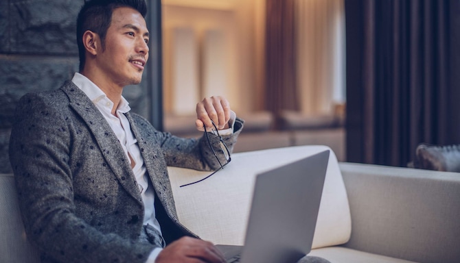 Marca Radisson Collection - Hombre en el vestíbulo conectado a wifi