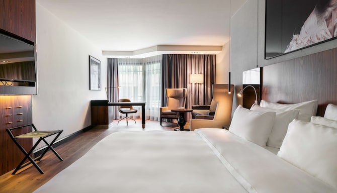 Radisson Collection Hotel, Grand Place Brussels - Junior Suite with bed, desk, and sitting area