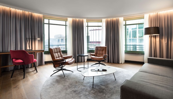 Radisson Collection Hotel, Grand Place Brussels - Suite living area with sofa-bed, desk and armchairs