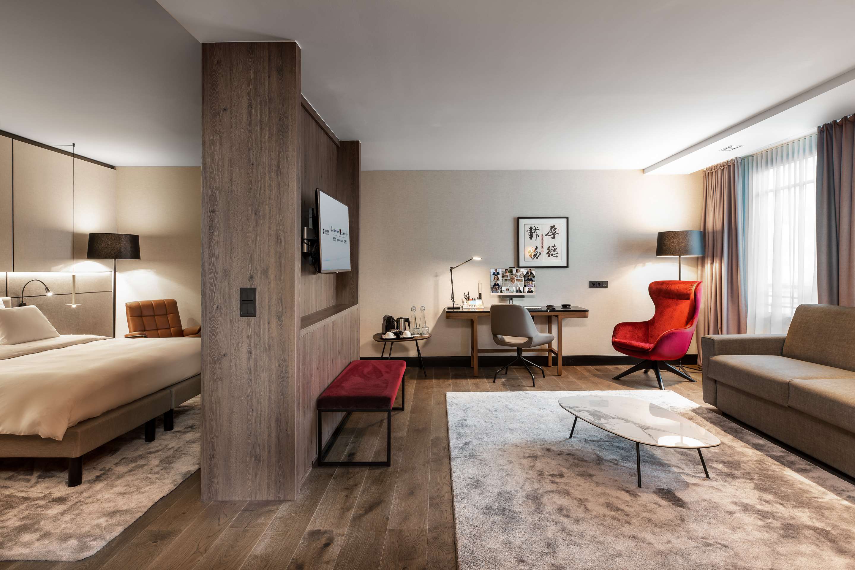 Radisson Collection Hotel, Grand Place Brussels - Premium Suite living area with sofa-bed and desk adjoining the bedroom area