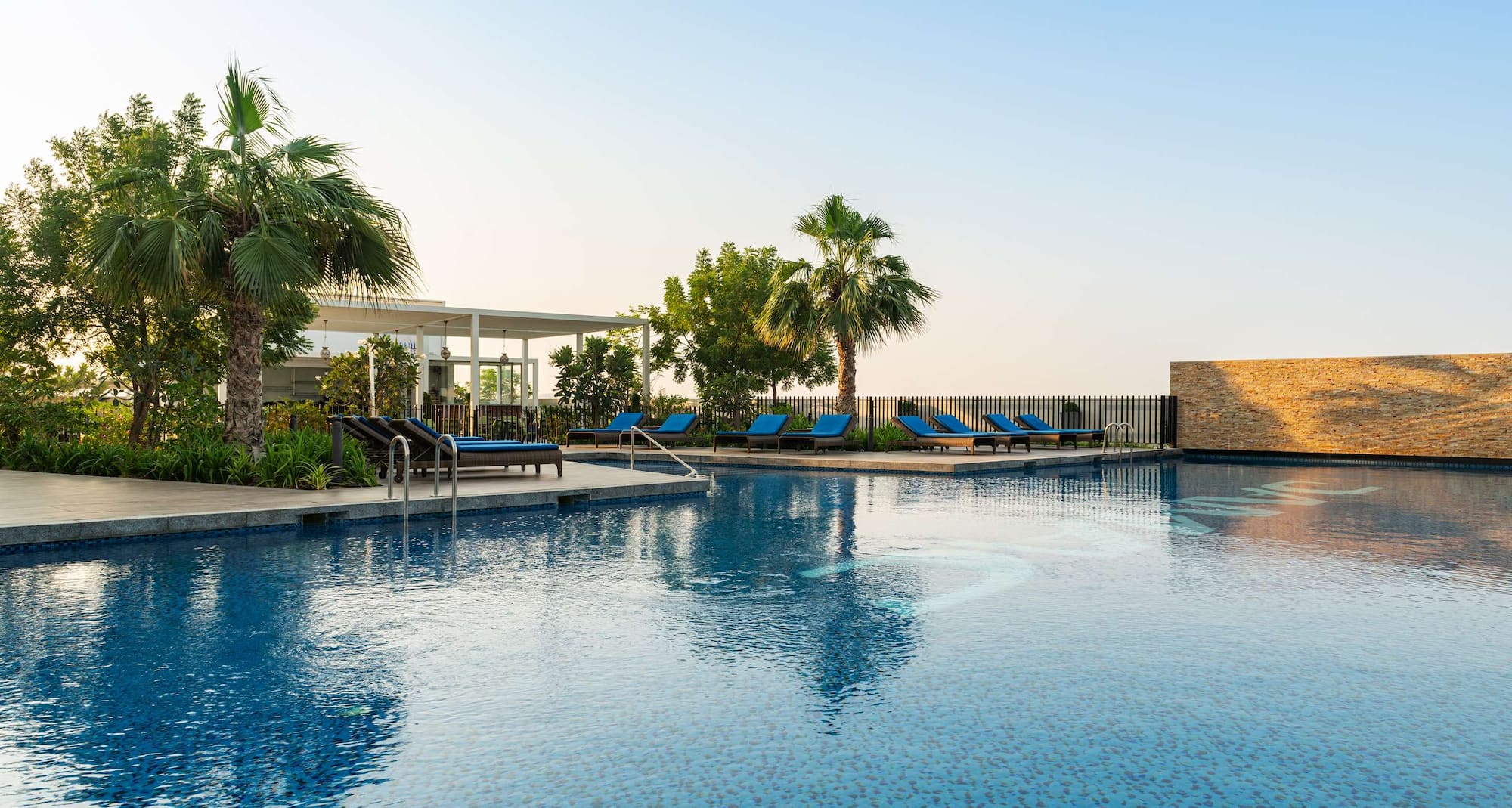 Radisson Hotel Dubai Damac Hills - Hills Pool Deck - Pool with Restaurant view