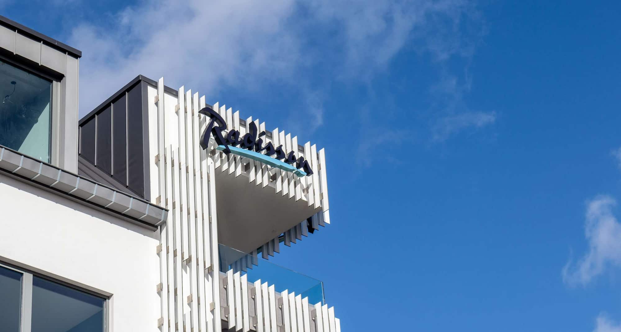 Radisson Hotel Liege City Centre - Building exterior and hotel logo