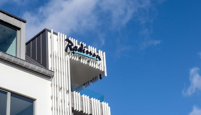 Radisson Hotel Liege City Centre - Building exterior and hotel logo