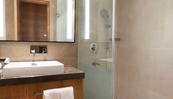 Radisson Hotel Vrindavan - Guest room bathroom with vanity & shower