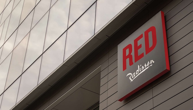 The Radisson RED sign on the exterior of a hotel