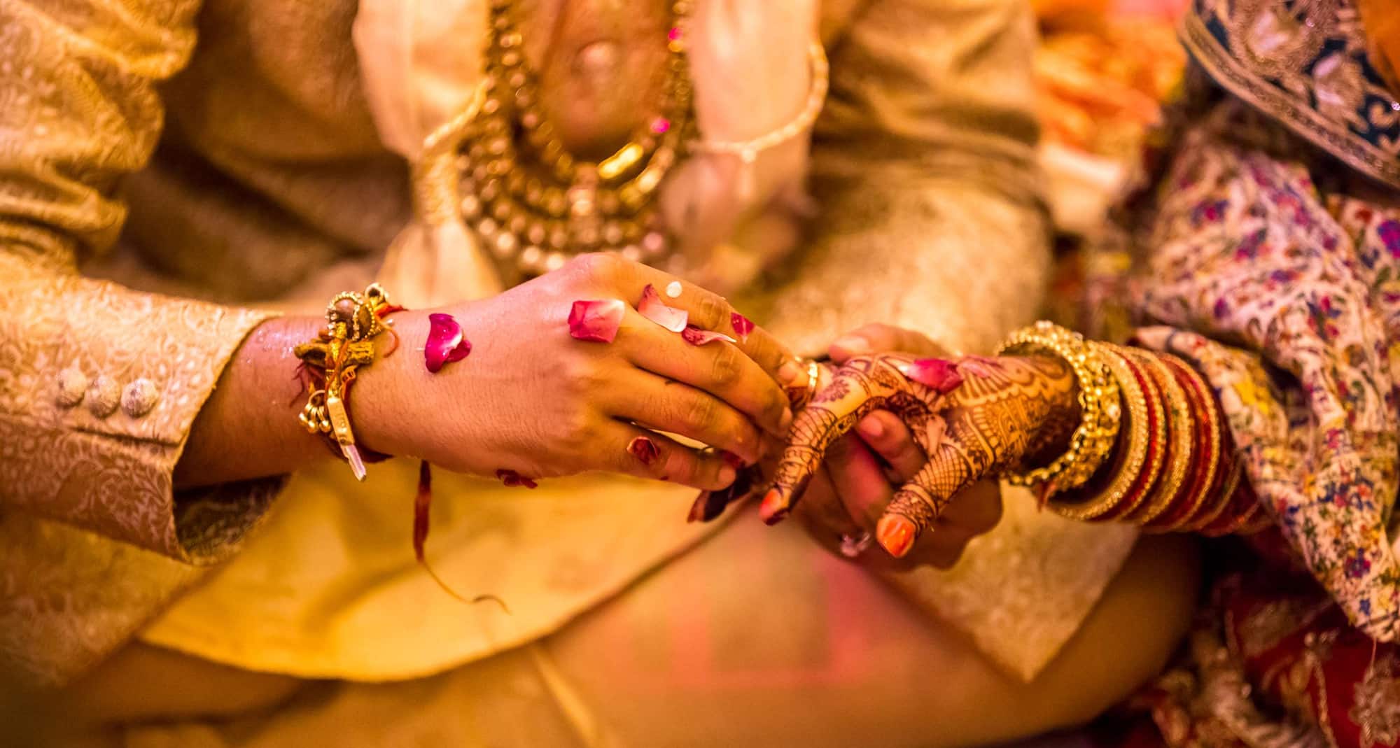 Weddings - Bride and Groom putting on a ring