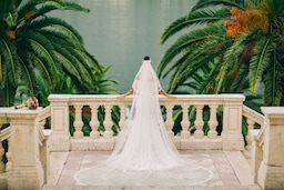 Weddings - Bride looking over garden