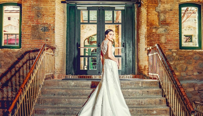 Weddings - Bride walking up interior stairs